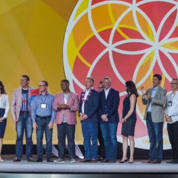 Event-Photography This image highlights Coldea Productions' ability to capture the lively ambiance of an event at the Long Beach Convention and Entertainment Center, with vibrant hanging lights illuminating a bustling crowd.