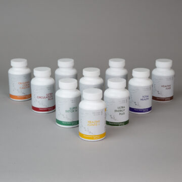 Nora Ross herbal supplement bottles arranged on a gray background, featuring products for health and wellness support