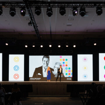 Event-Photography Speakers presenting on a large stage with dynamic visuals at the San Diego Convention Center, captured by Coldea Productions.