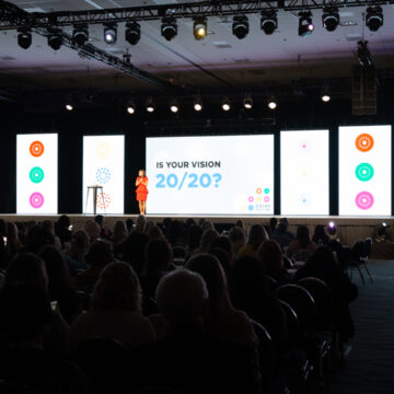 Event-Photography A group celebrates their Platinum status on stage at Santa Clara Convention Center, captured by Coldea Productions during an award ceremony.