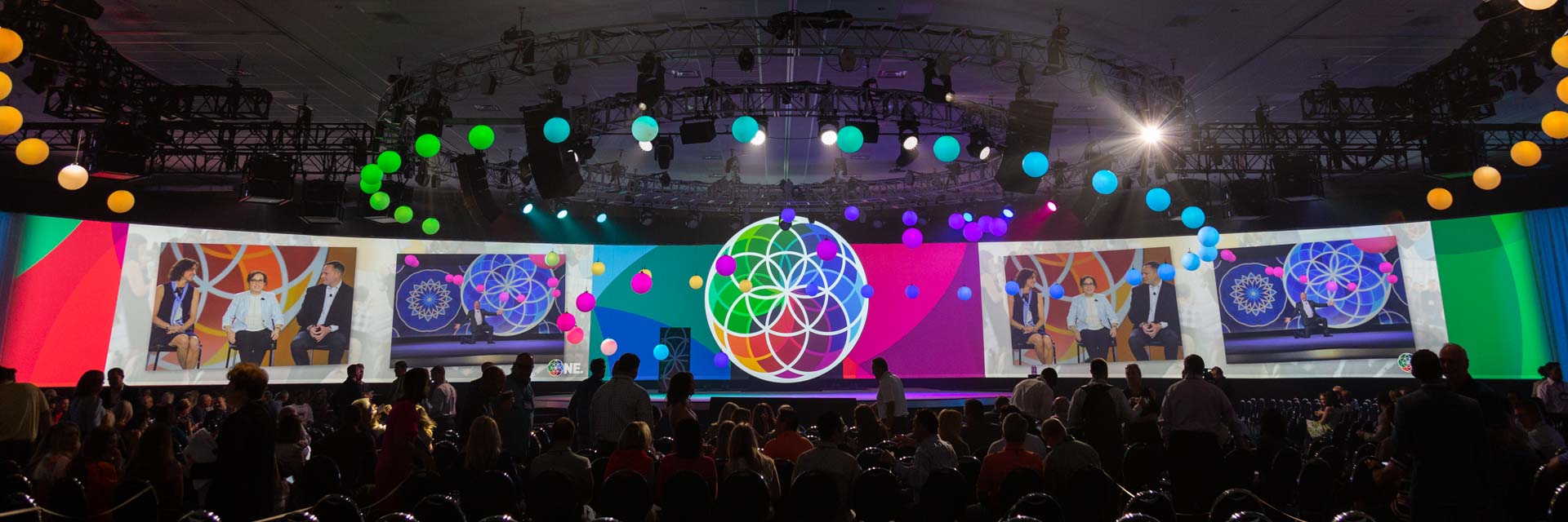 Conference-Photography Audience gathering at the ONE conference with vibrant stage design and screen projections, captured by Coldea Productions to showcase the event’s dynamic atmosphere.