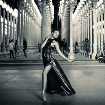 Elegant dancer posing at night in a glamorous dress at LACMA's "Urban Light" installation, captured by Coldea Productions in a blend of fashion and dance photography