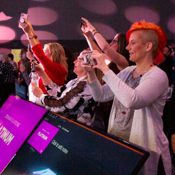 Convention-Photography Coldea Productions captures an engaged audience photographing the Modere Platinum award ceremony at Anaheim Convention Center, emphasizing the crowd's enthusiasm and celebratory atmosphere