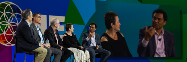 Conference-Photography This image showcases a panel discussion at the ONE conference, featuring industry experts on stage with a live projection of a speaker for audience engagement. Coldea Productions documented the event, delivering high-quality photography that emphasizes the conference’s scale and the presence of influential speakers, providing a lasting visual record of key moments.