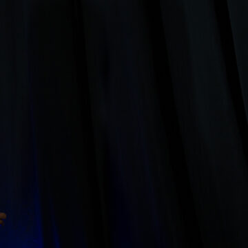 Convention-Photography Motivational speaker preparing for her presentation backstage, captured in dramatic lighting by Coldea Productions