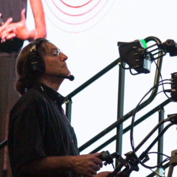 Convention-Photography Camera operator recording a speaker at the Los Angeles Convention Center, captured by Coldea Productions during a live event