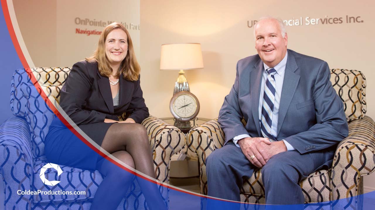 Two professionals from UBS Financial Services, seated in an office setting, smiling during an interview for a financial video presentation produced by Coldea Productions.