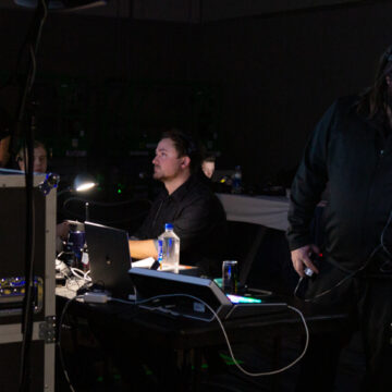 Technical crew at the control station during a live conference, managing audiovisual equipment.