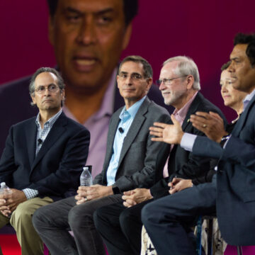 Event-Photography Panel discussion at a convention with industry experts sharing insights on stage, enhanced by Coldea Productions’ event photography