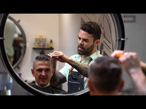 Barber cutting a client’s hair in a stylish barbershop, featured in a presentation video for Founding Fathers Collective in Prescott, AZ.