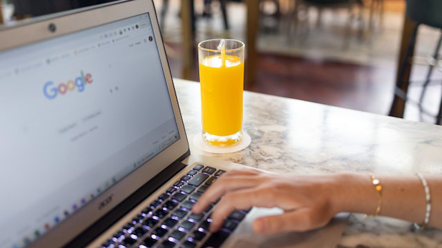A person using Google search on a laptop
