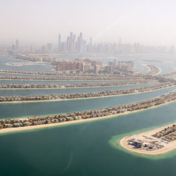 An aerial view of Dubai's Palm Jumeirah, showcasing the iconic man-made island structures and luxury properties, captured as part of Coldea Productions' aerial drone photography services.