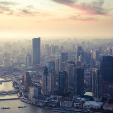 Drone-captured aerial view of a city skyline at sunrise, showcasing Coldea Productions’ drone and aerial photography services.