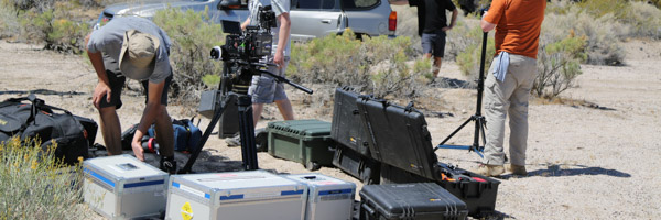 A film production crew setting up equipment in a desert location, representing Coldea Productions' expertise in film production and aerial drone videos.