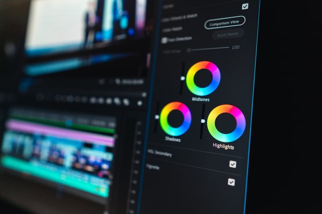 Close-up of a video editing software interface with color grading tools for midtones, shadows, and highlights, representing Coldea Productions' video editing services.