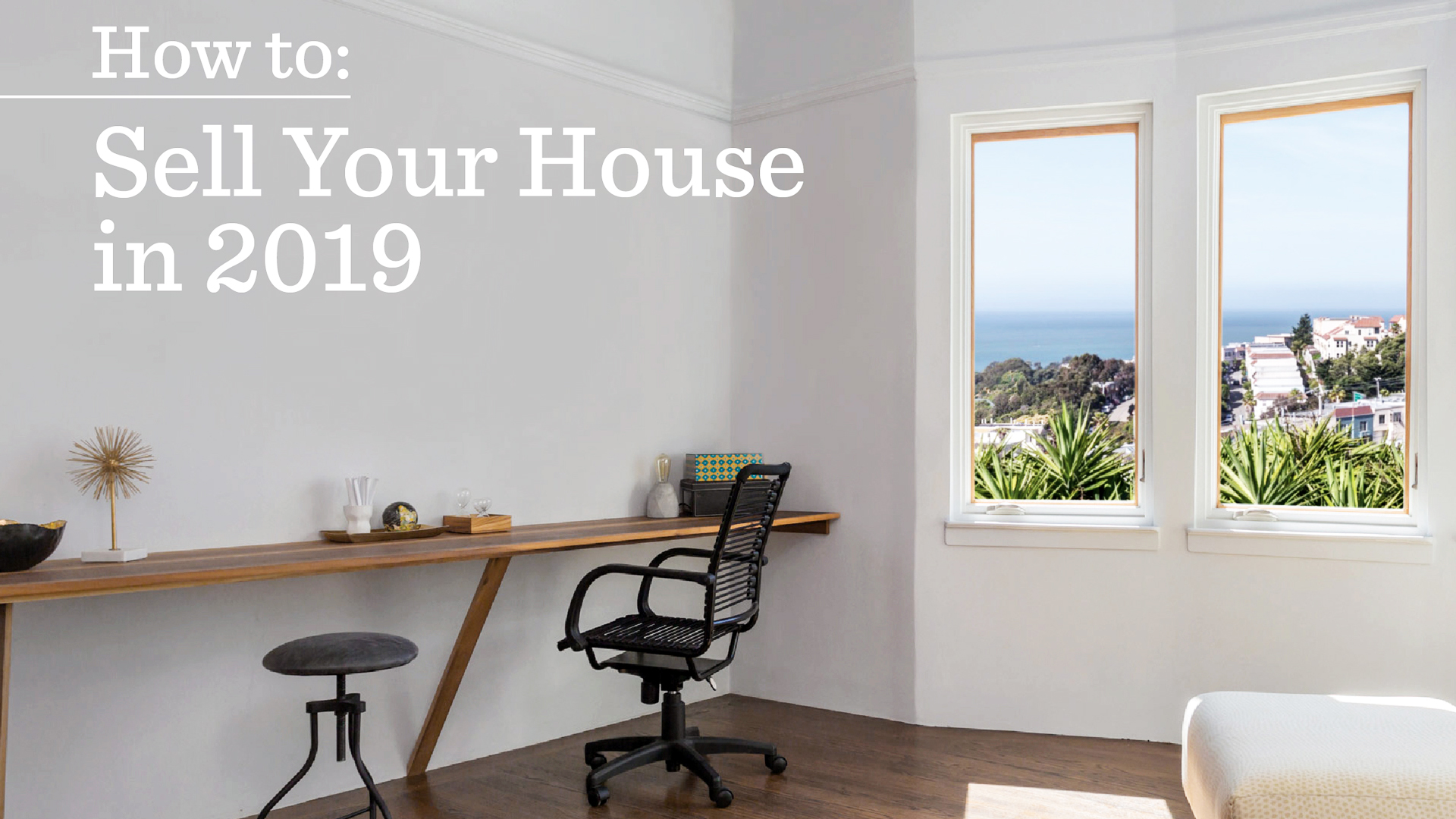 Bright and modern home office with large windows offering scenic views, showcasing interior design for selling your house in 2019