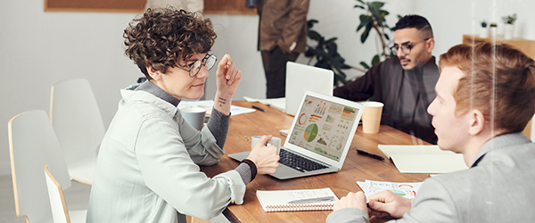 Professionals collaborating in an office setting, representing the creation of company training and recruitment videos by Coldea Productions.