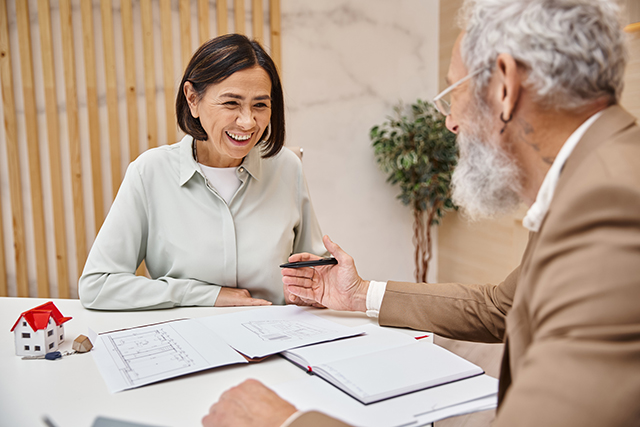 Smiling woman consulting with a professional on estate planning, symbolizing expert advice and personalized service.