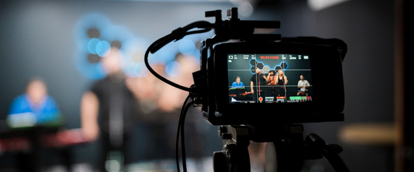 Professional camera capturing a corporate team event, ideal for corporate video production services by Coldea Productions.