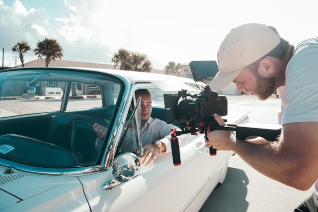 Filmmaker capturing a luxury car video scene with a professional camera rig for Coldea Productions’ automotive video marketing project.