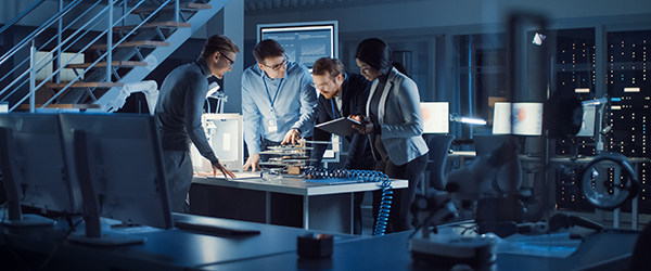 Team in a high-tech manufacturing facility reviewing safety protocols.