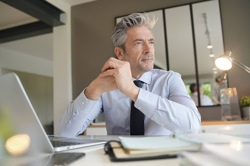 Professional real estate lawyer in office planning video marketing strategy to build authority and attract clients.