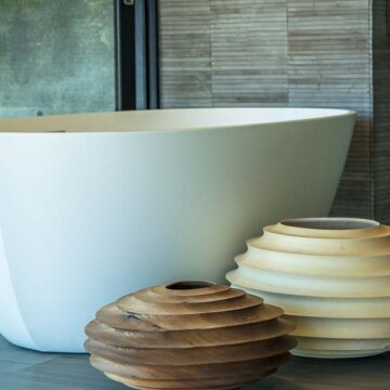 Modern bathroom with a stylish freestanding tub and decorative wooden elements, showcasing Coldea Productions' real estate photography services.