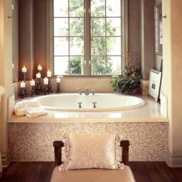Luxurious bathroom interior with a large tub, candles, and elegant decor, highlighting Coldea Productions' real estate photography services.