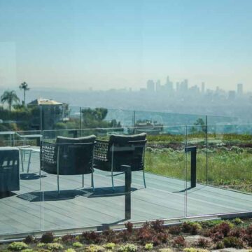 Outdoor patio with modern seating overlooking downtown Los Angeles, captured by Coldea Productions for real estate photography