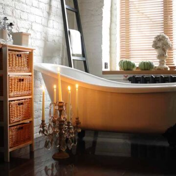 Elegant bathroom interior with vintage tub and candles, captured by Coldea Productions for real estate photography