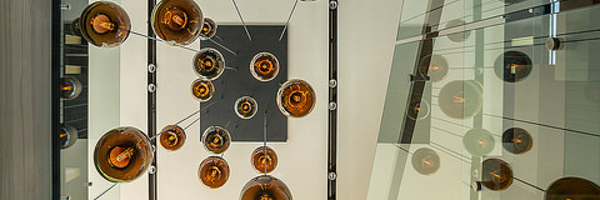 A creative interior view featuring hanging light fixtures captured from below, showcasing the artistic detail possible with professional product photography and videography.