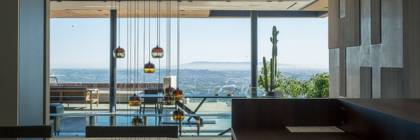 A modern home interior with floor-to-ceiling windows and stunning city views, representing Coldea Productions' expertise in real estate video and photography.
