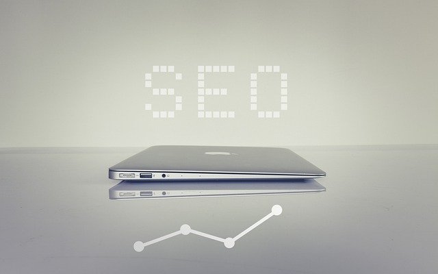 Laptop with the word "SEO" and a rising graph icon, symbolizing the long-term investment of SEO strategies