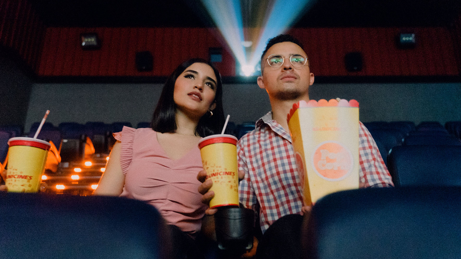 A couple enjoying a cinematic experience at a theater, representing the ambiance of film festivals like the Tribeca Film Festival, captured to highlight storytelling and film production services.
