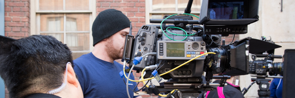 Coldea Productions team filming a commercial with professional video equipment on an urban set.