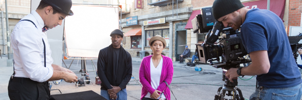Film crew capturing a scene with actors on a city street set, part of Coldea Productions' video commercial services in Long Beach, California