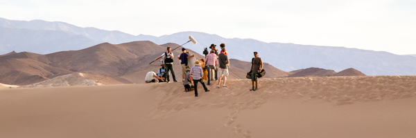 Video production crew filming on a desert landscape in Phoenix, Arizona, representing Coldea Productions' video production services.