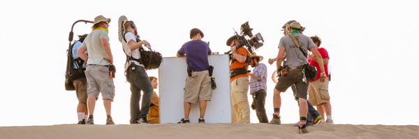 Film crew preparing for a video shoot on a sandy landscape, demonstrating Coldea Productions' video production services in Riverside, California