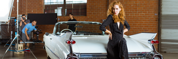 Coldea Productions filming a model posing with a classic convertible on set in Corona, California, during a commercial video shoot.