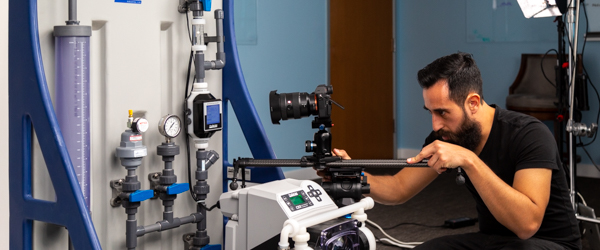 Alexis Mendez from Coldea Productions filming a Plastic Chemical Feed Skid with professional video equipment.