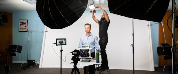 Rob Gledhill of Blue-White Industries demonstrates Plastic Chemical Feed Skids, with Alexis Mendez from Coldea Productions filming the product video.