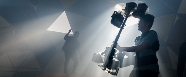 Cinematographer using a stabilizer rig on a creative set with dramatic lighting, ideal for video production companies in Phoenix, AZ, by Coldea Productions.