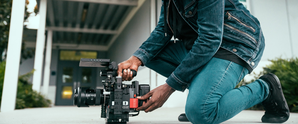 Videographer setting up a professional camera for an outdoor shoot, ideal for video production services in Scottsdale, AZ, by Coldea Productions.