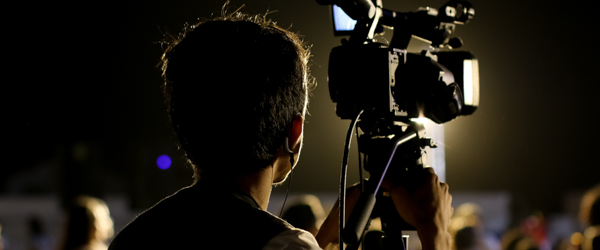 Videographer filming an event with professional camera equipment, ideal for video production services in Scottsdale, AZ, by Coldea Productions.