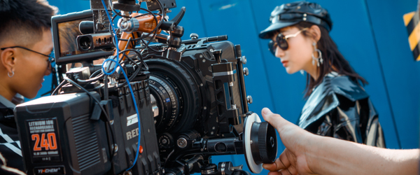 Professional videographer capturing a stylish model on set, ideal for video production services in Phoenix, AZ, by Coldea Productions.