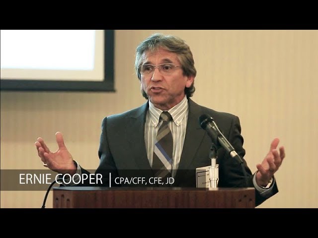 Ernie Cooper, CPA/CFF, CFE, JD, giving a presentation at a podium with a microphone, captured during a professional speaking event.
