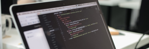 A laptop screen displaying coding and programming scripts, representing Coldea Productions' expertise in web video production services for digital platforms.