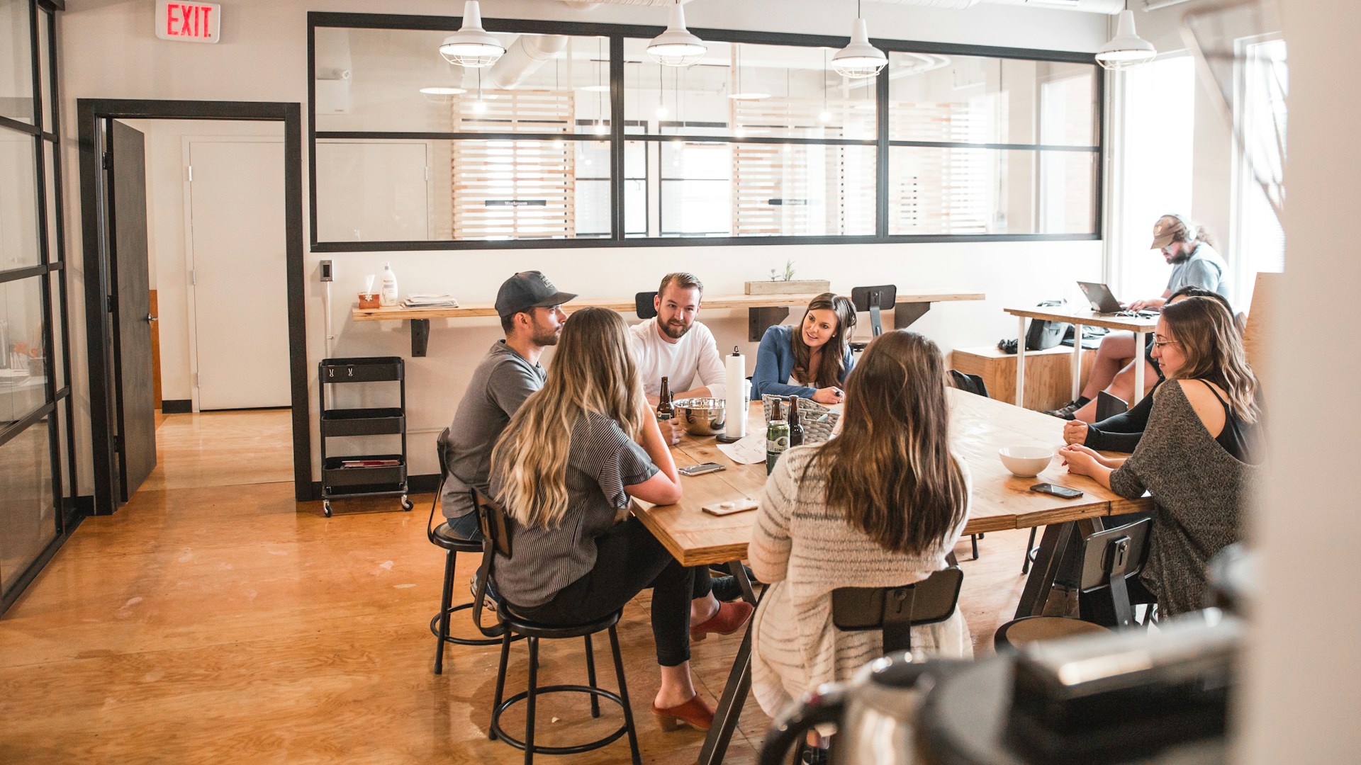 A group of people sitting in an office setting.